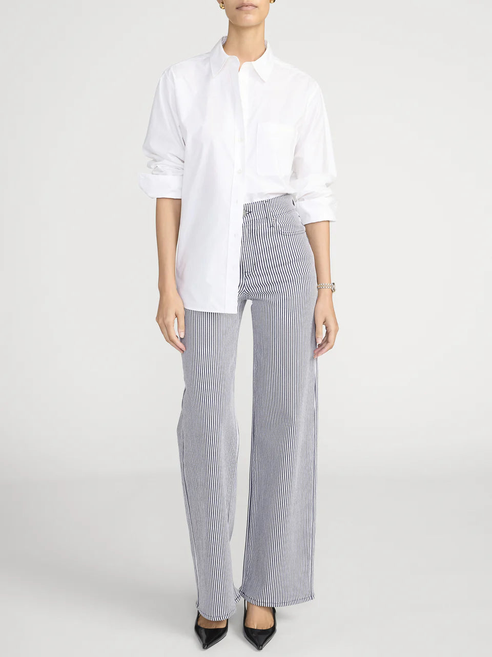 Person wearing a white shirt and gray striped pants on a white background