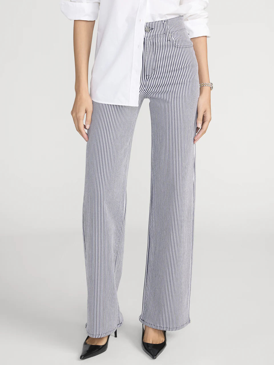 Person wearing black and white striped pants on a white background