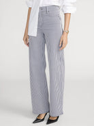 Person wearing blue and white striped pants on a white background