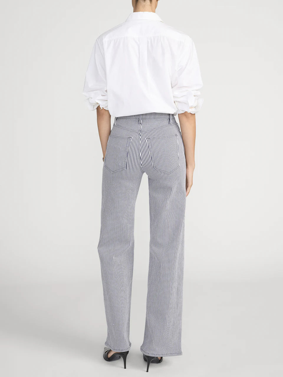 Person wearing a white shirt and gray striped pants on a white background