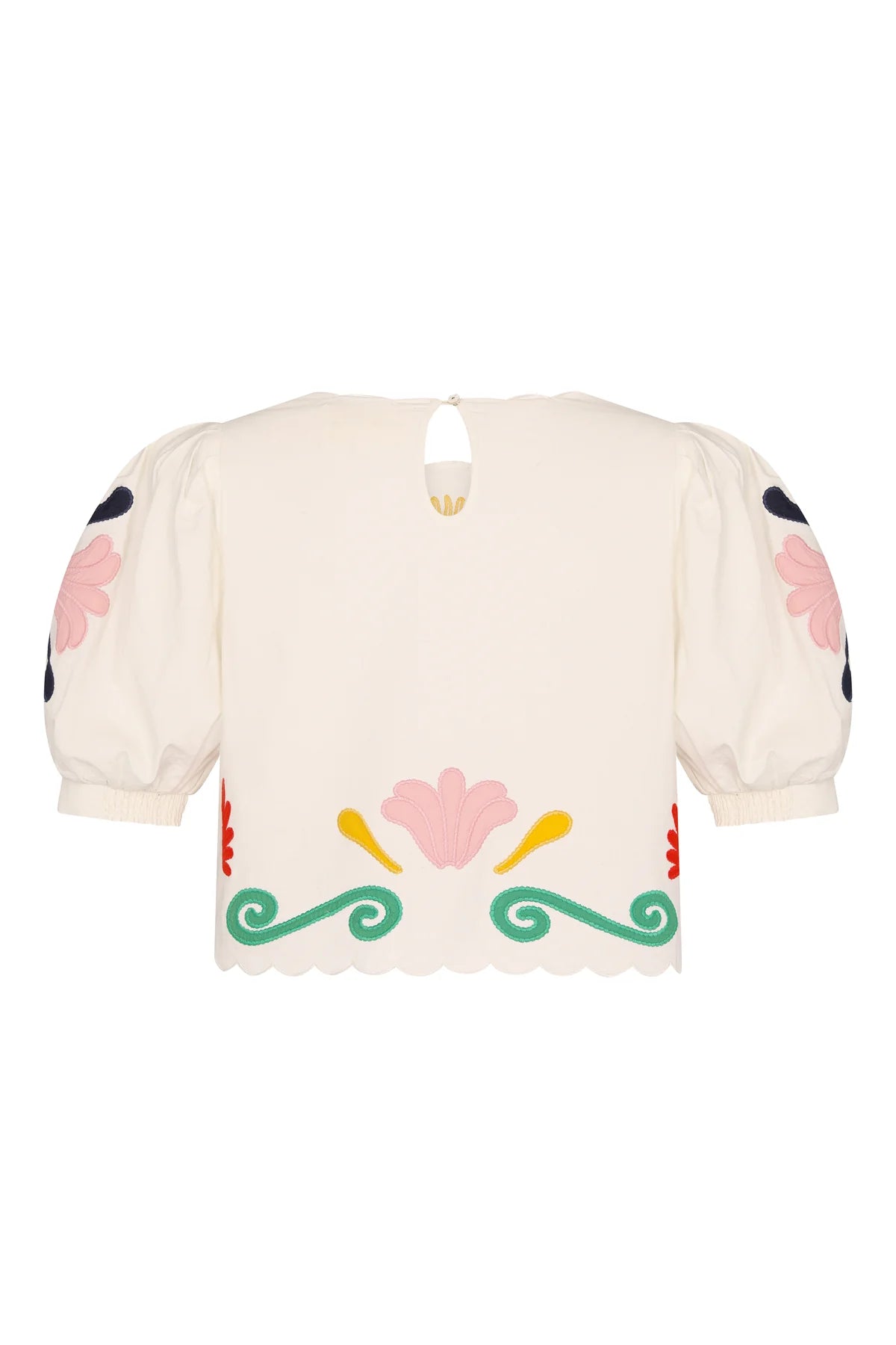 Cream-colored blouse with floral and decorative patterns on a white background