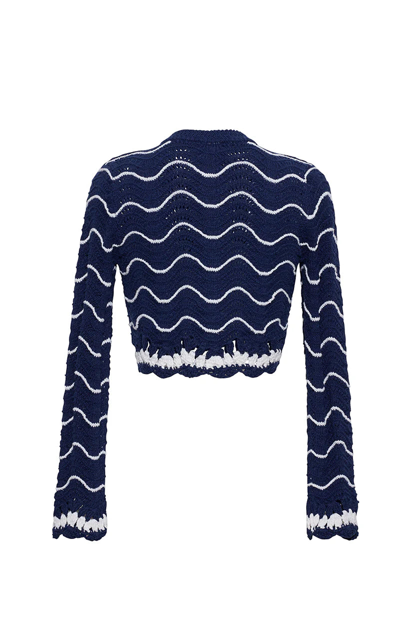 Navy blue sweater with white wavy patterns on a white background