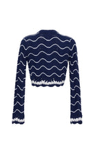 Navy blue sweater with white wavy patterns on a white background
