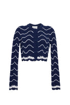 Navy blue cardigan with white wave pattern on a white background