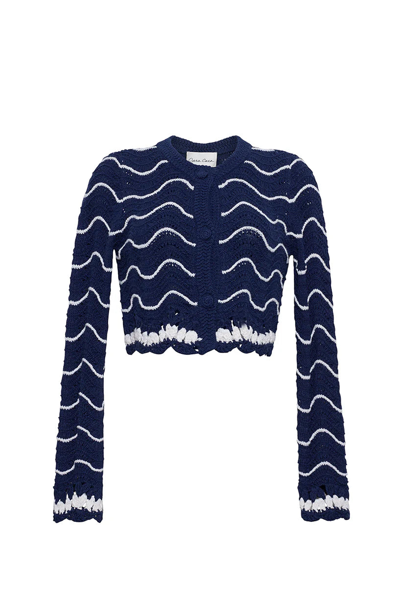 Navy blue cardigan with white wave pattern on a white background