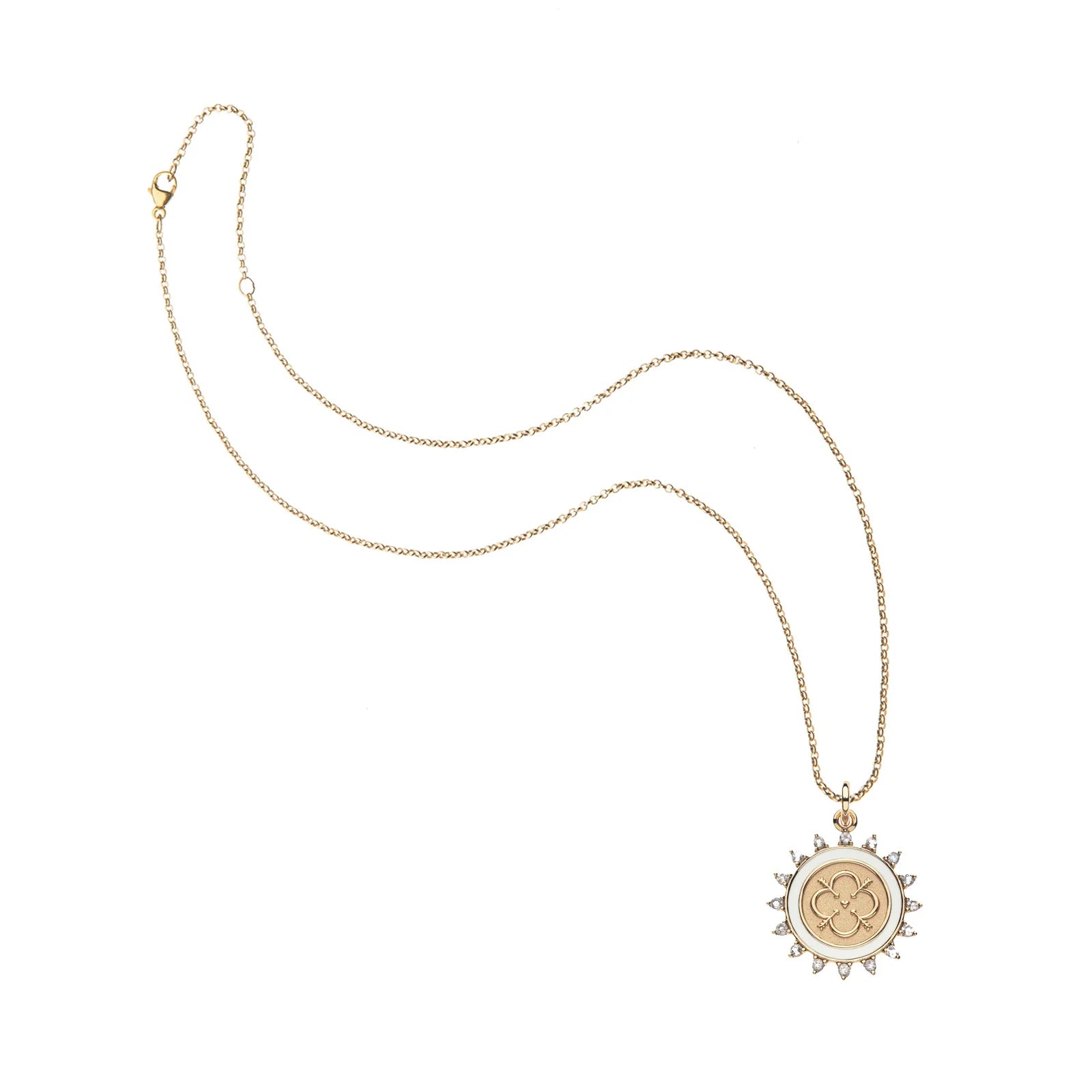 A delicate gold chain necklace with a circular pendant featuring a central gold monogram and a sunburst border accented with small clear stones, shown on a plain white background.