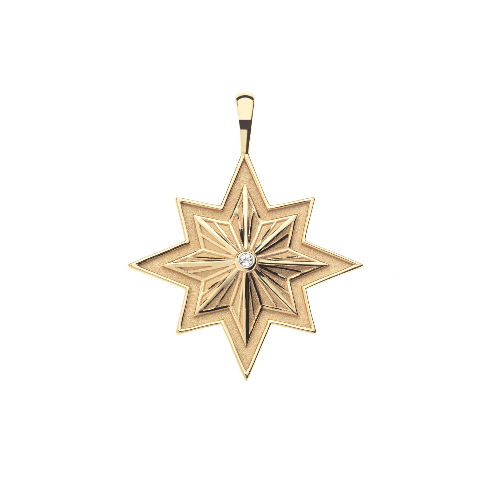 Gold pendant in the shape of an 8 pointed star with a central diamond gem and an engraved border on a white background