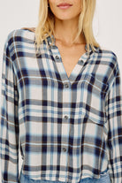 Plaid shirt worn by a person on a white background