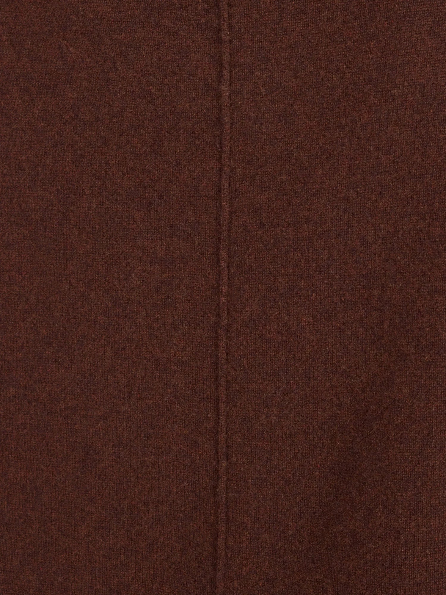 A close-up of a dark brown textured fabric with a central vertical seam.