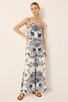 Woman wearing a floral patterned dress against a plain background