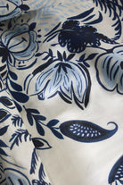 Close-up of blue floral pattern on white fabric