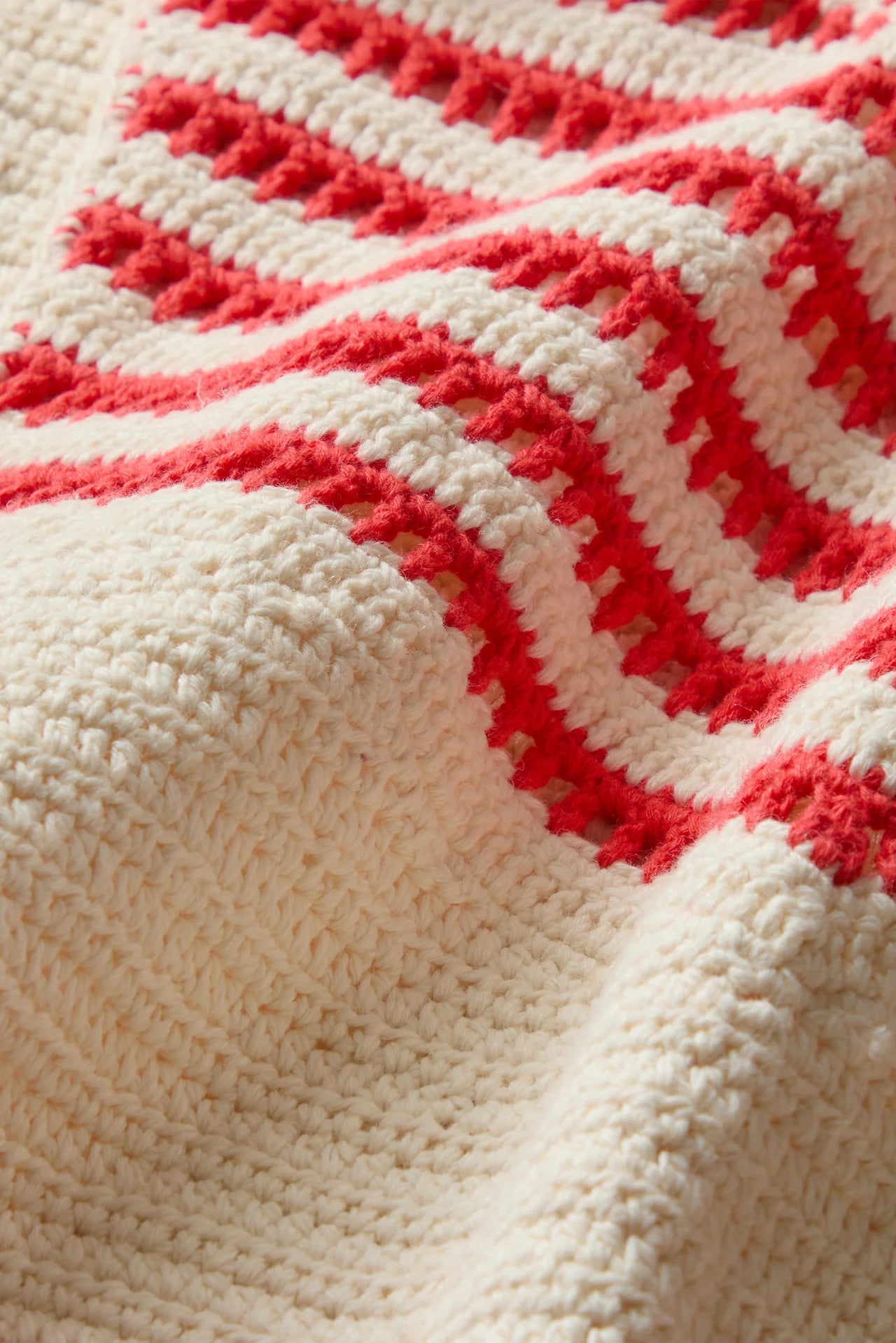 Close-up of a crocheted blanket with red and white pattern