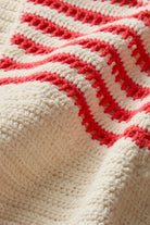 Close-up of a crocheted blanket with red and white pattern