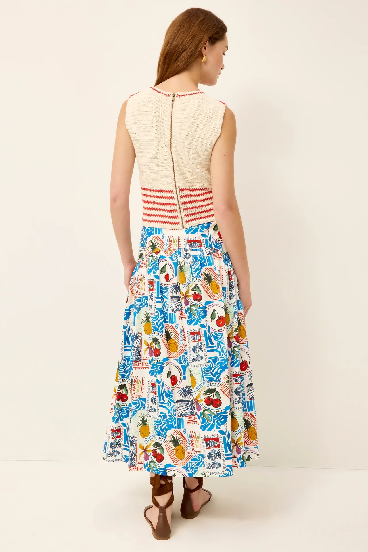 Woman wearing a colorful patterned dress with a white background