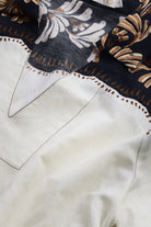 Close-up of a shirt with floral embroidery on a dark background