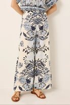 Person wearing a floral patterned outfit on a plain background