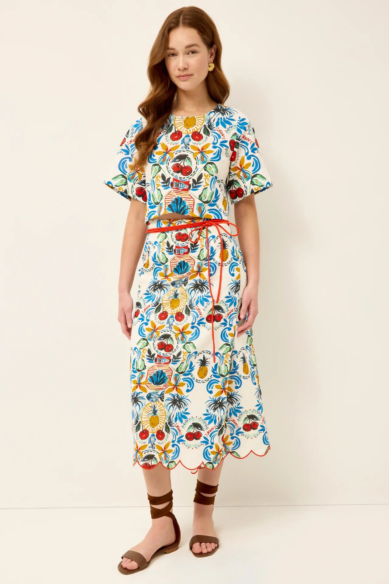 Woman wearing a colorful floral dress on a white background