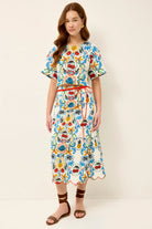 Woman wearing a colorful floral dress on a white background
