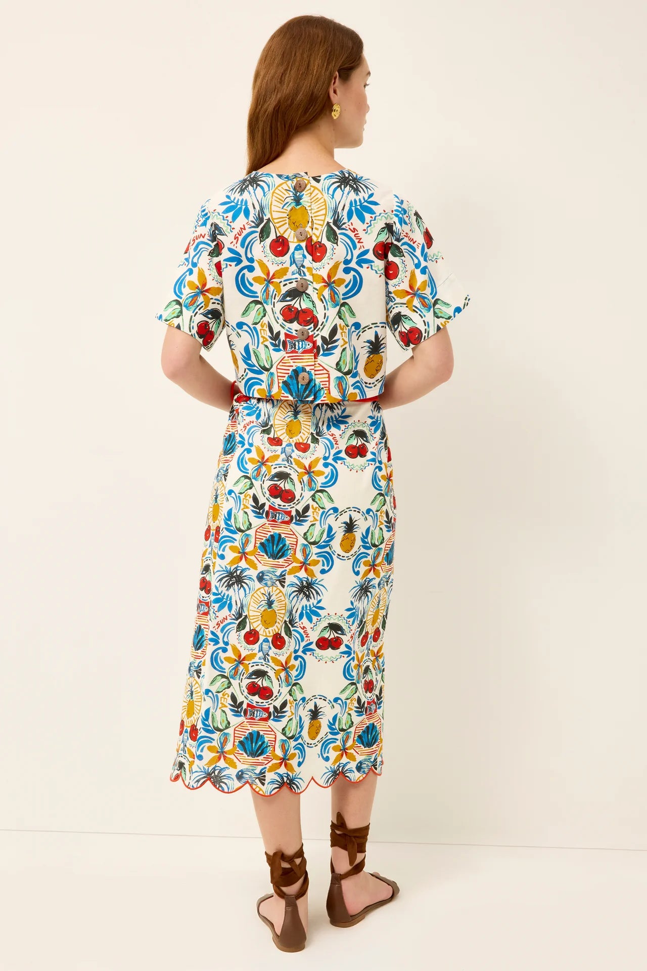 Woman wearing a colorful floral dress on a white background