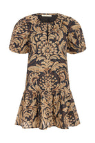 Patterned dress with gold and black design on a white background