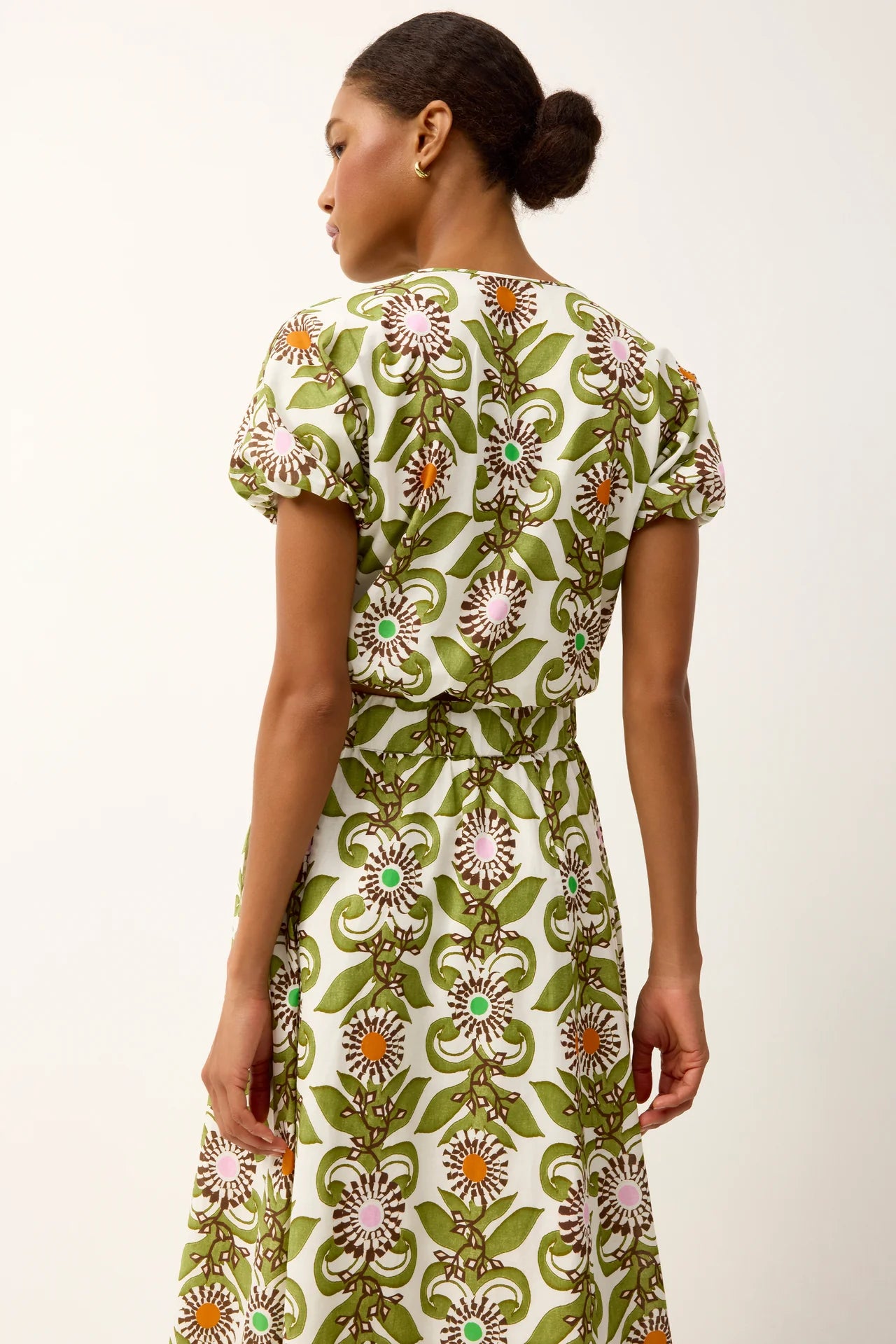 Woman wearing a floral dress with a white background