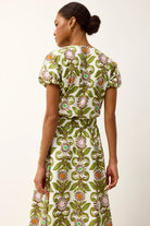 Woman wearing a floral dress with a white background