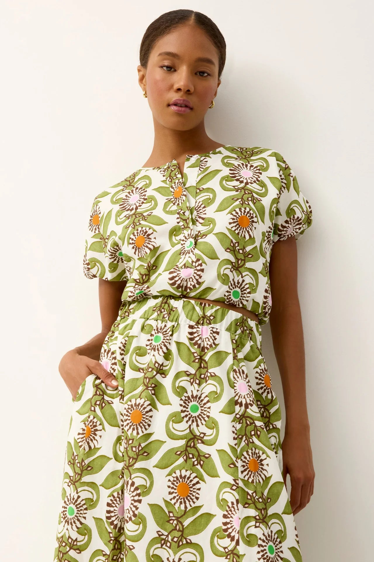 Woman wearing a floral dress with a white background