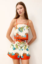 Woman wearing a colorful floral dress with a white background