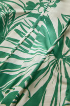 Close-up of green leaf pattern fabric on a white background