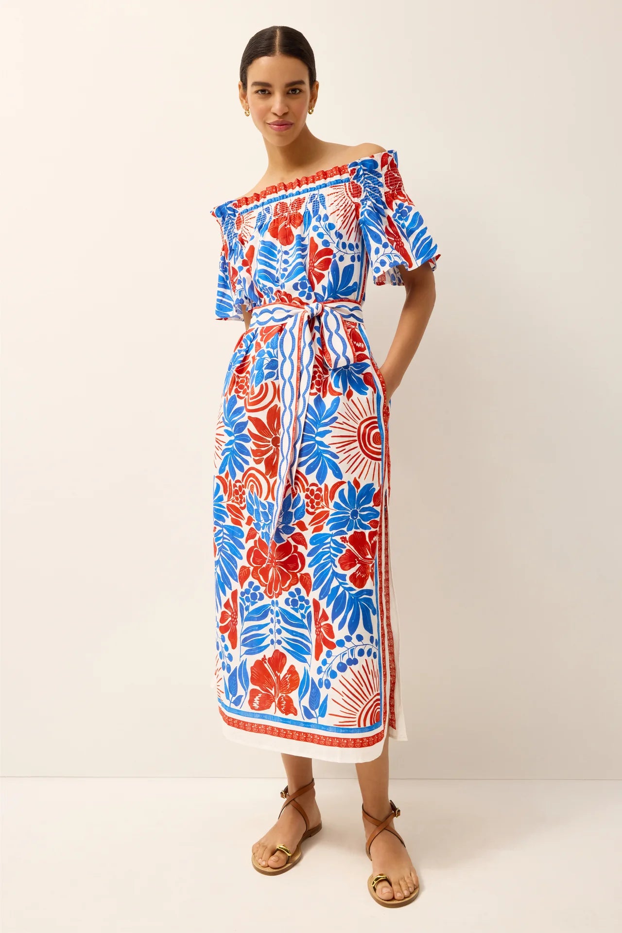 Woman wearing a colorful floral dress on a white background