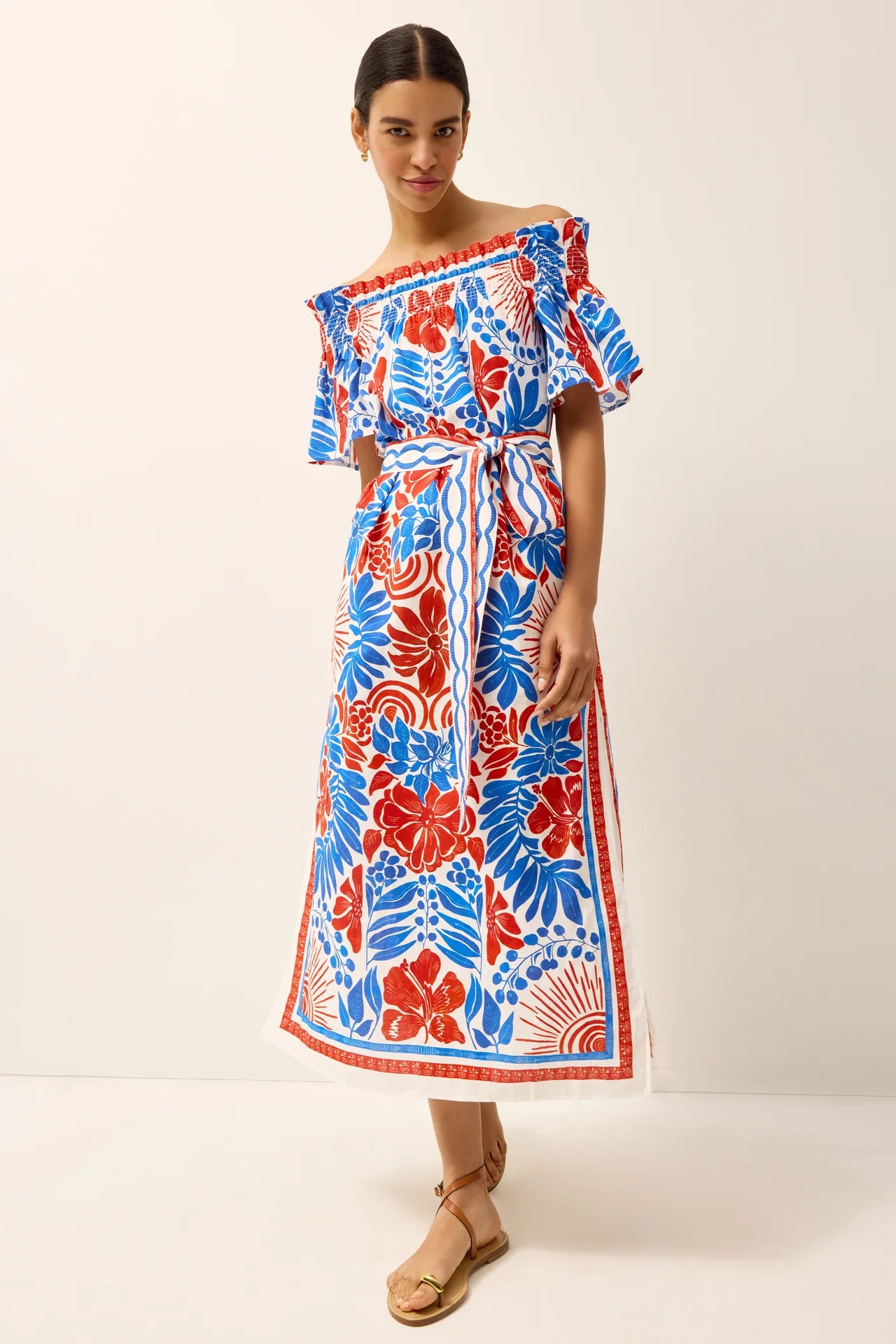 Woman wearing a colorful floral dress on a white background