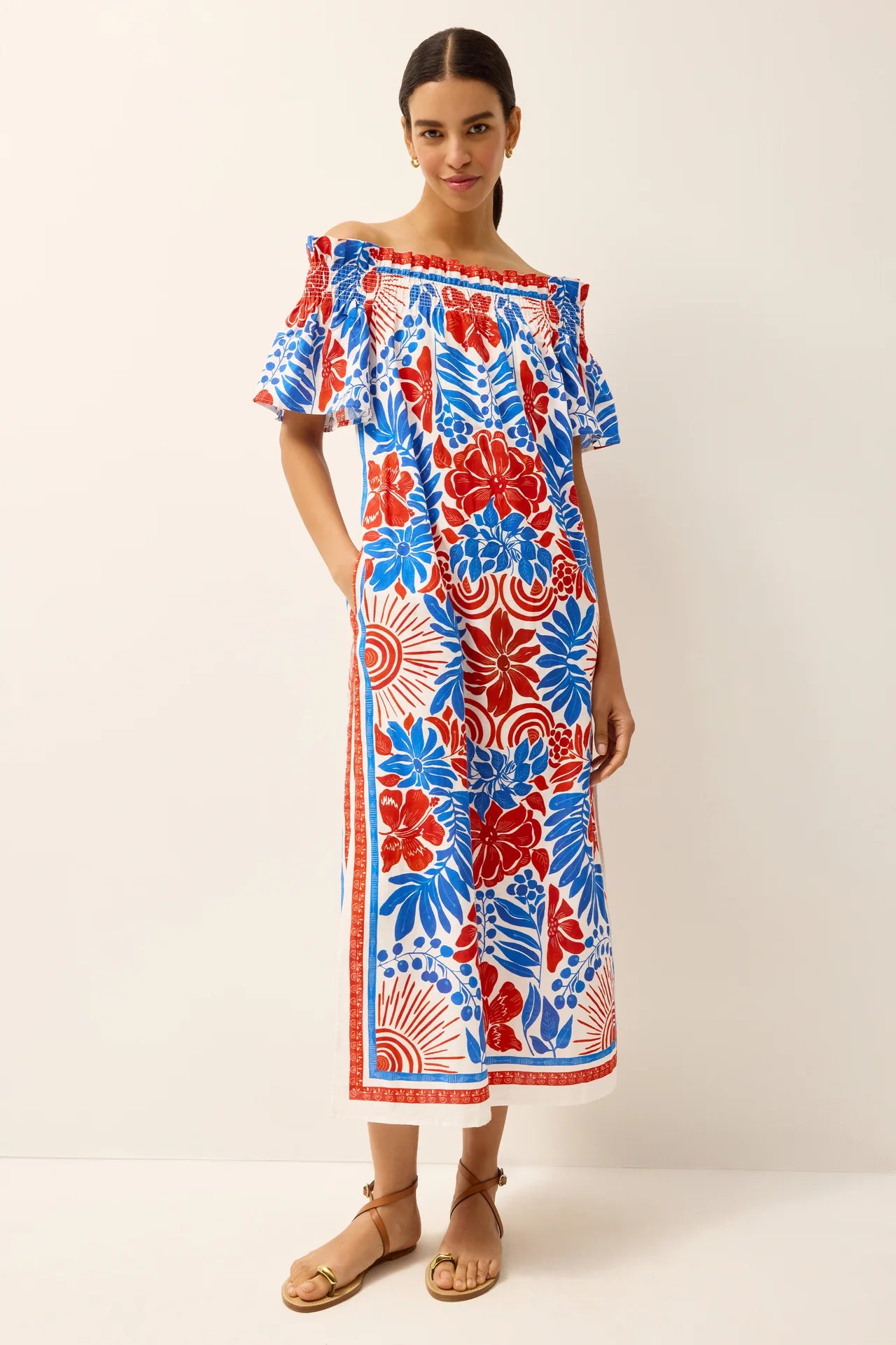 Woman wearing a colorful floral dress on a white background