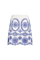 White skirt with blue floral embroidery on a white background