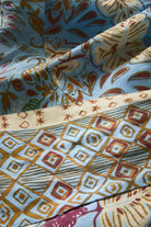 Close-up of patterned fabric with geometric and abstract designs.