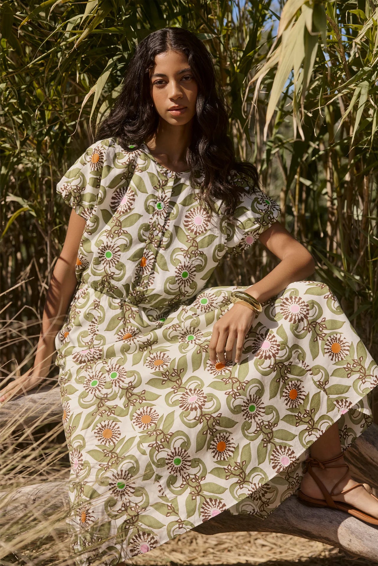 Woman wearing a floral dress in a natural setting