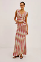 Woman wearing a striped outfit on a white background
