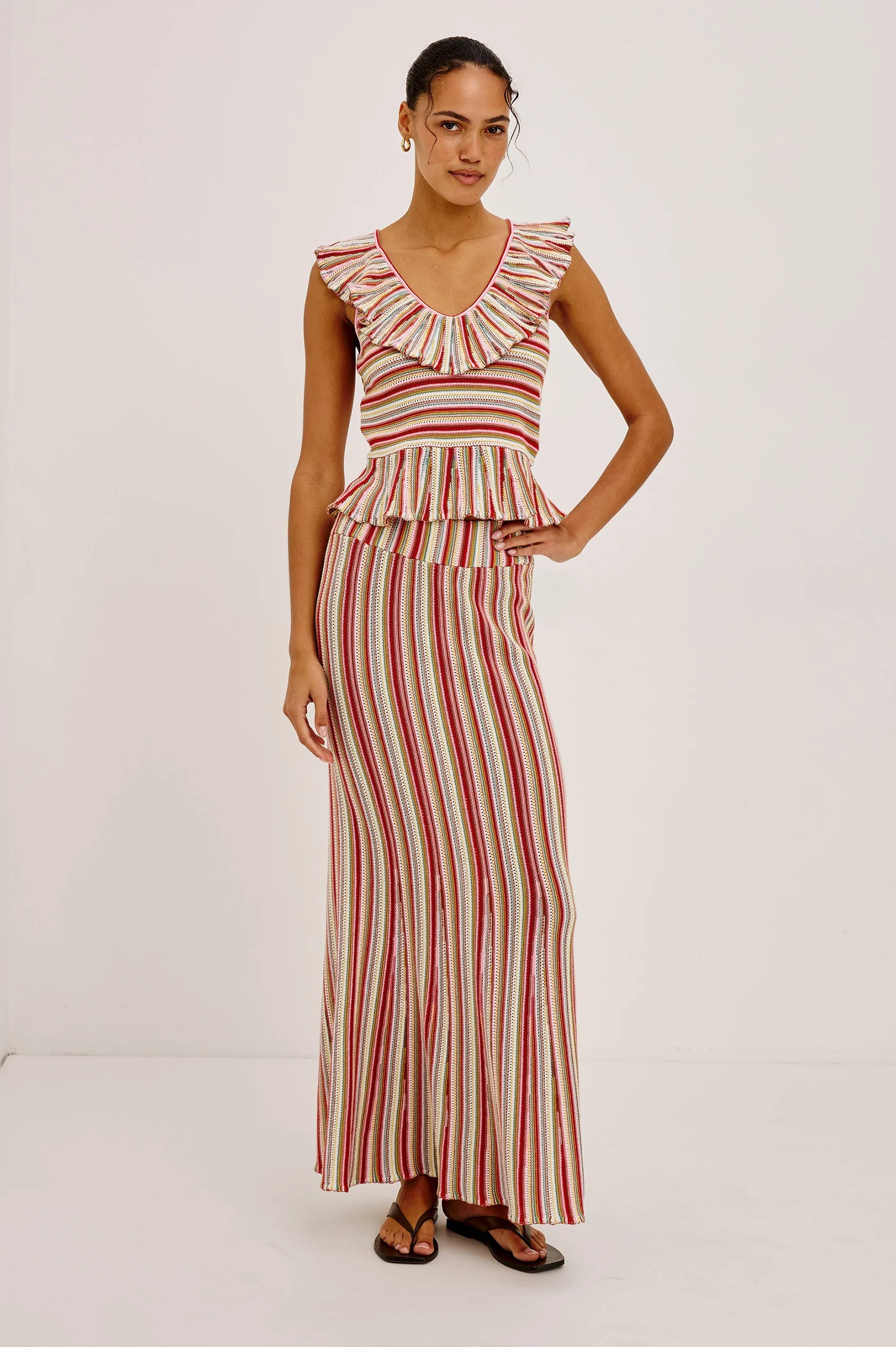 Woman wearing a red and white striped dress on a white background