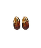Pair of gold hoop earrings with amber-colored stones on a white background