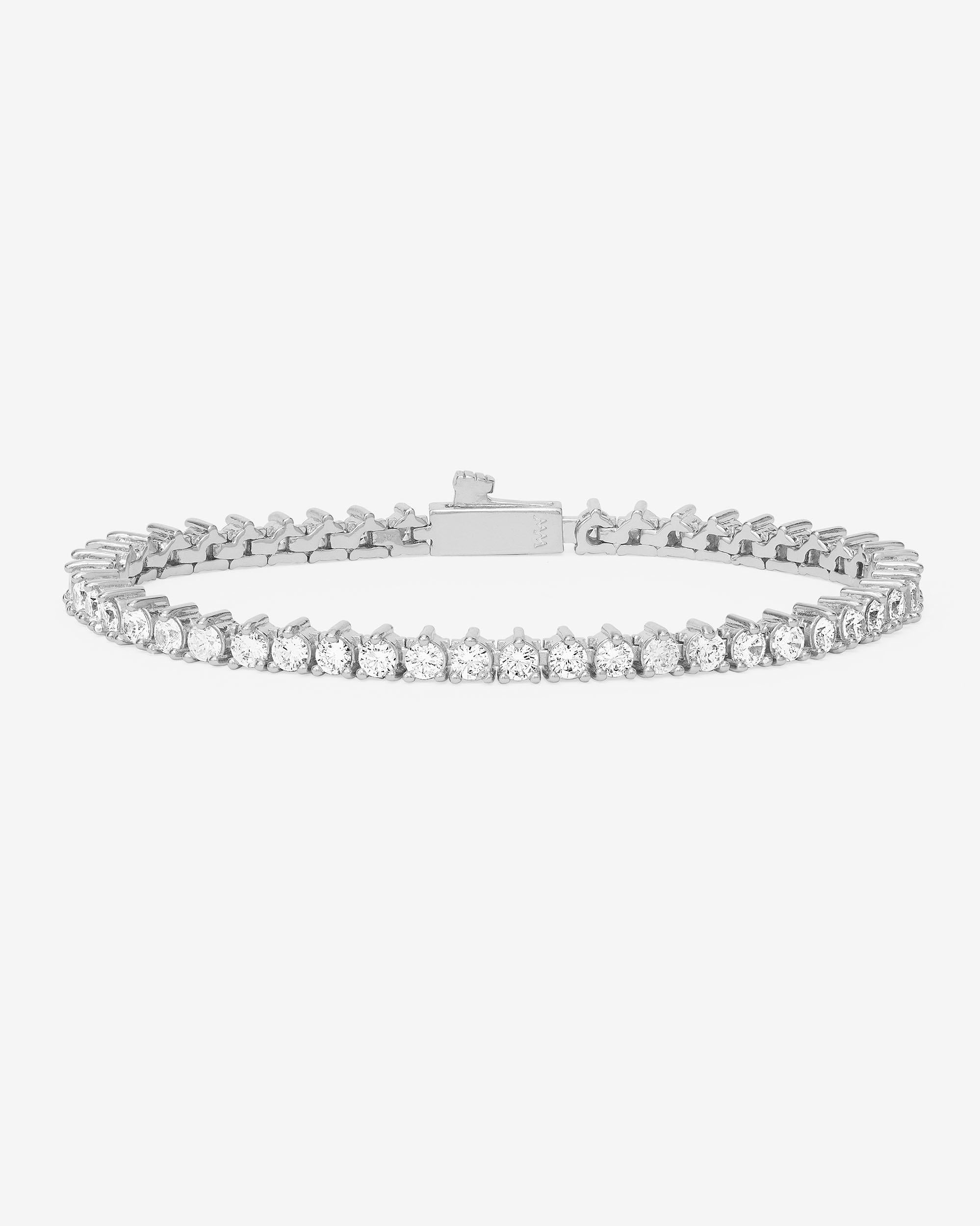 Silver bracelet with clear stones on a white background