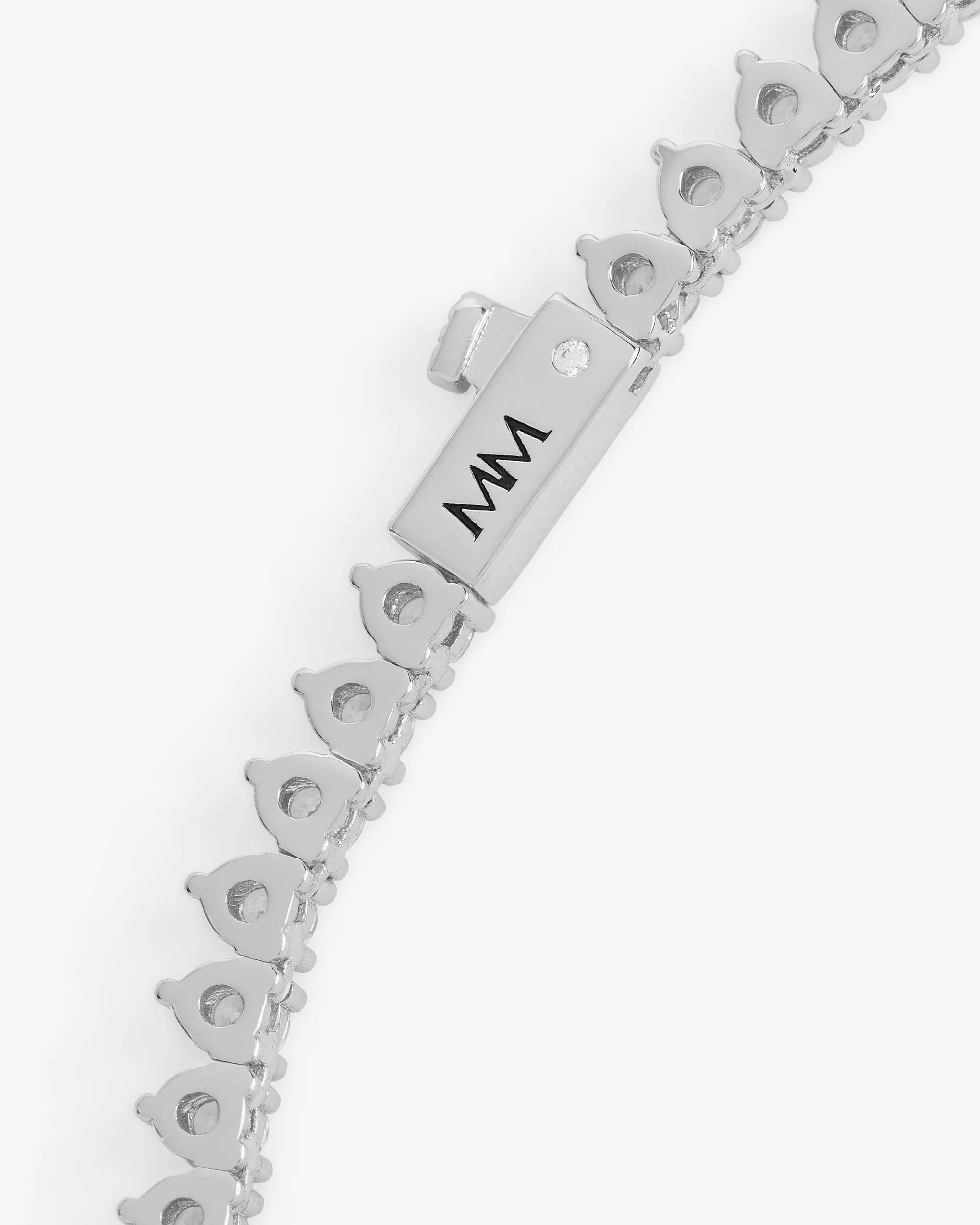 Silver bracelet with a clasp and 'MM' engraving on a white background