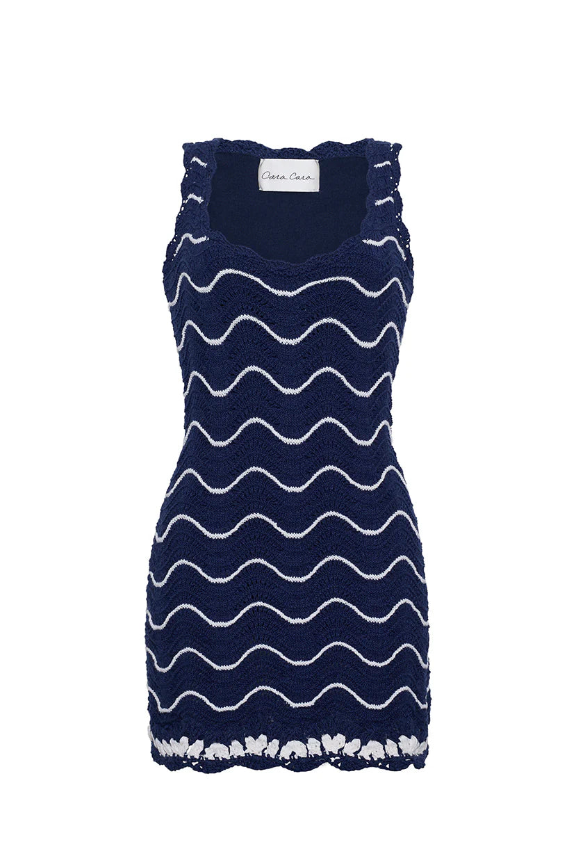 Navy dress with white wave pattern on a white background