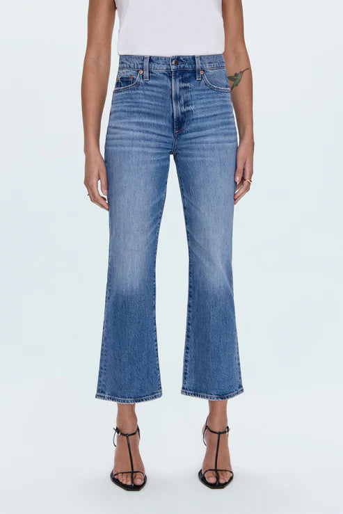 Person wearing blue jeans on a white background