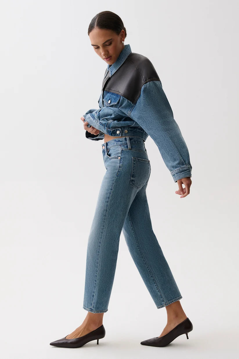 Woman wearing a denim outfit with a white background