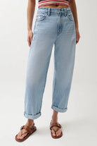 Light blue jeans worn by a person on a white background