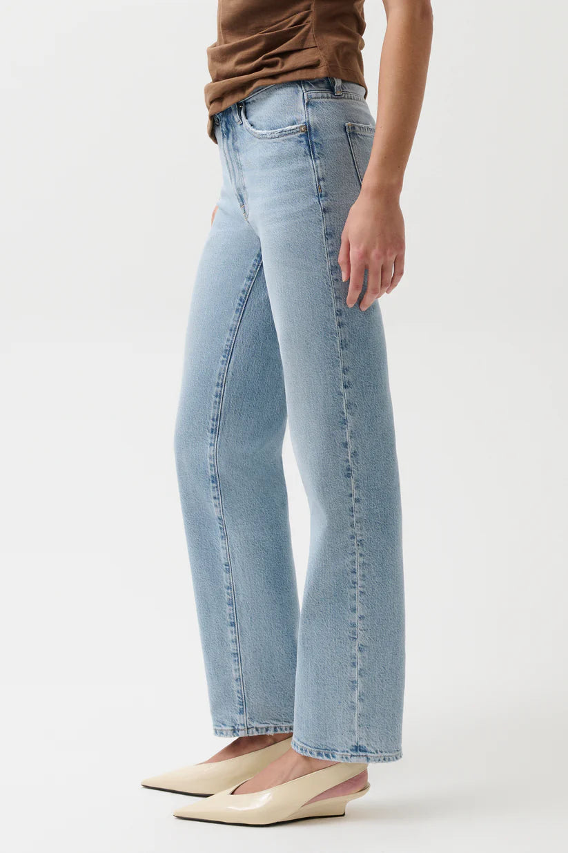 Light blue jeans worn by a person on a white background