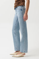 Light blue jeans worn by a person on a white background