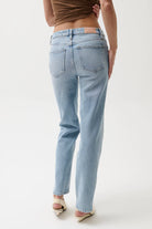 Light blue jeans worn by a person on a white background