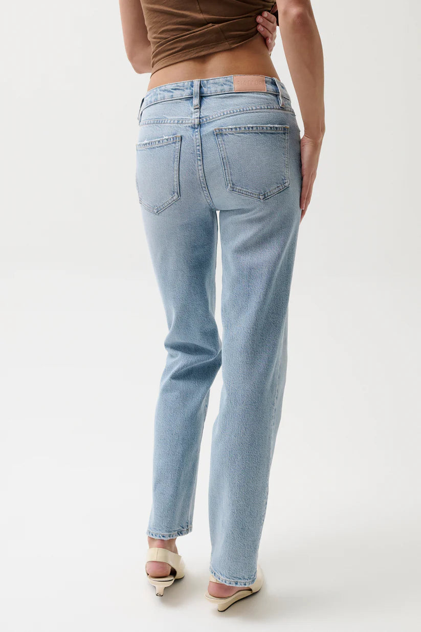 Light blue jeans worn by a person on a white background