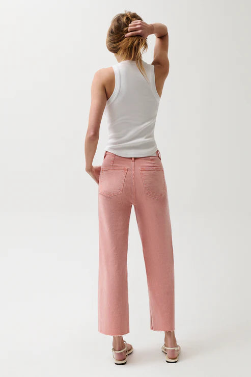 Person wearing a white tank top and pink pants on a white background