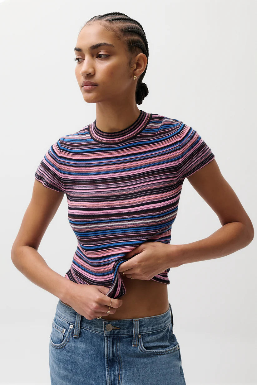 Woman wearing a striped shirt and jeans on a white background